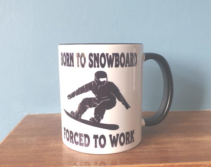 Snowboarding mug with humourous theme and the wording 'Born to Snowboard, Forced to work'