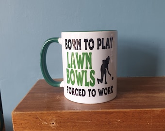 Lawn Bowls mug with humourous theme and the wording 'Born to play Lawn Bowls, Forced to work'