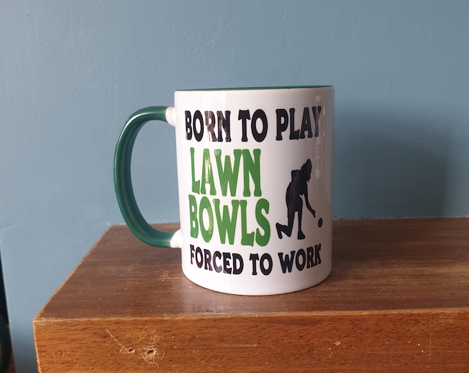 Lawn Bowls mug with humourous theme and the wording 'Born to play Lawn Bowls, Forced to work'