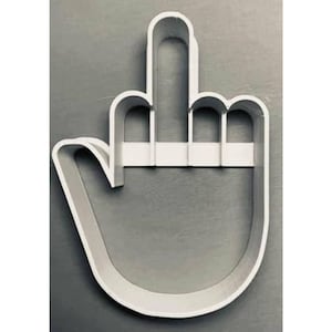 May include: White plastic cookie cutter shaped like a hand giving the middle finger.