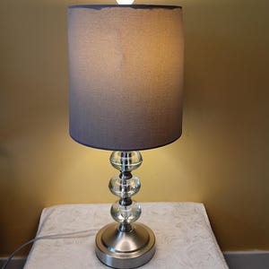 Crystal and Silver Table Lamp with glass orbs. It is 20 in tall to the top of the finial. Great Pre-Owned Condition