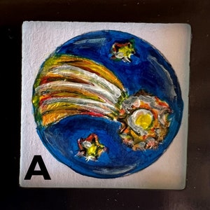 May include: A painting of a comet with a bright yellow tail streaking across a blue sky with white and yellow stars. The painting is on a white background with the letter "A" in the lower left corner.