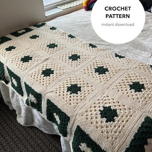 May include: A crocheted blanket with a white background and green squares. The blanket is on a bed with a white sheet and a pillow. The text "CROCHET PATTERN instant download" is on a white circle.