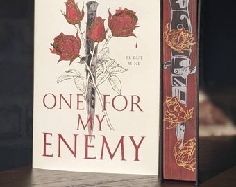May include: A book cover with a white background and red text. The title is "One for My Enemy" by Olivia Blake. The cover features a drawing of a knife and roses with the text "Be But Mine".