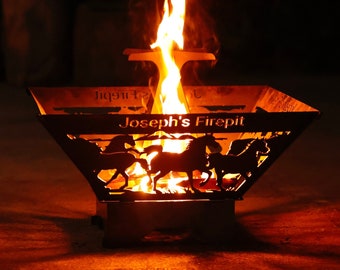 May include: A black metal fire pit with a cutout design of horses and the text "Joseph's Firepit". The fire pit is lit and flames are visible.