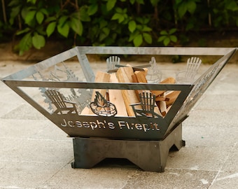 May include: A metal fire pit with a personalized inscription "Joseph's Firepit". The fire pit is shaped like a square with rounded corners and has a decorative design of trees and Adirondack chairs cut out of the metal. The fire pit is sitting on a raised base and has a few pieces of firewood inside.