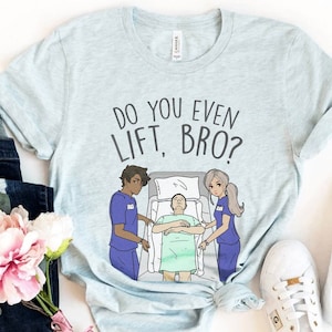 May include: Light blue t-shirt with the text "Do you even lift, bro?" printed on it. The design features a cartoon illustration of three people in a hospital room.