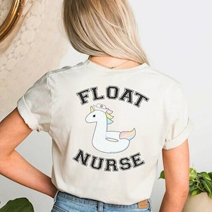 May include: White t-shirt with a graphic of a unicorn wearing a nurse's hat and a floatie. The text "FLOAT NURSE" is printed in black letters.