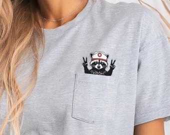 Raccoon Nurse Pocket T-Shirt, Cute Feral RN Raccoon pocket tee, gift for LPN, Registered Nurse Trendy Pocket Tee | ER Icu Peds Med Surg Gift