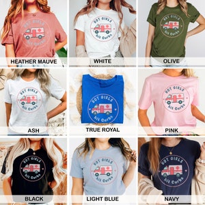 May include: A collection of t-shirts in various colours featuring a graphic of a cartoon ambulance with the text "Hot Girls Hit Curbs".