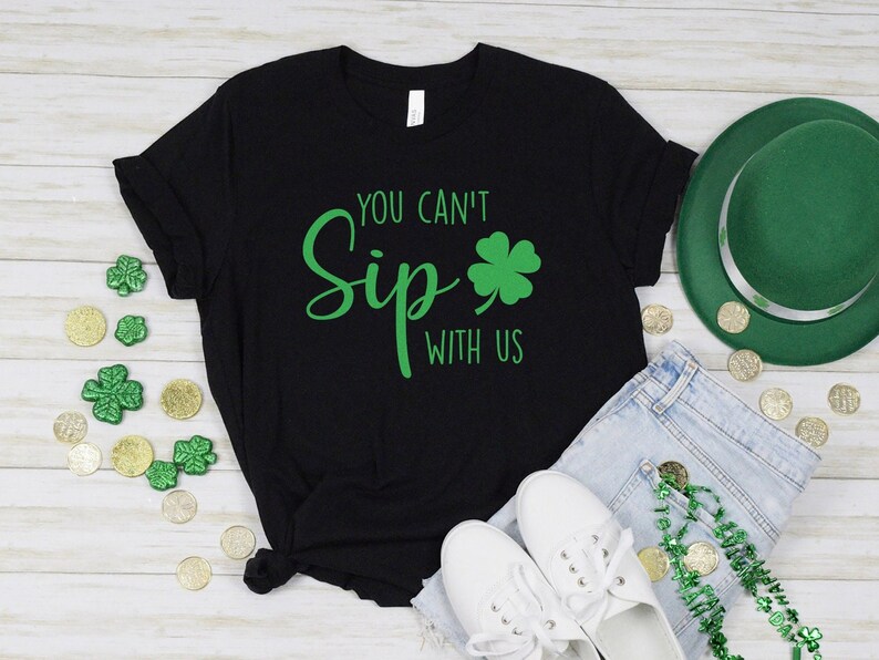 May include: Black t-shirt with green shamrock and the text "You can't Sip with us".