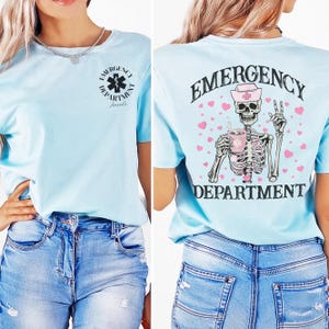 May include: Light blue t-shirt with a skeleton wearing a nurse's hat and holding a coffee mug. The text "EMERGENCY DEPARTMENT" is printed on the back of the shirt.