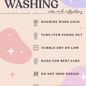 May include: A pink and purple graphic with white stars and instructions for washing an item. The instructions include machine wash cold, turn item inside out, tumble dry on low, hang for best care, do not iron design, and do not use bleach.