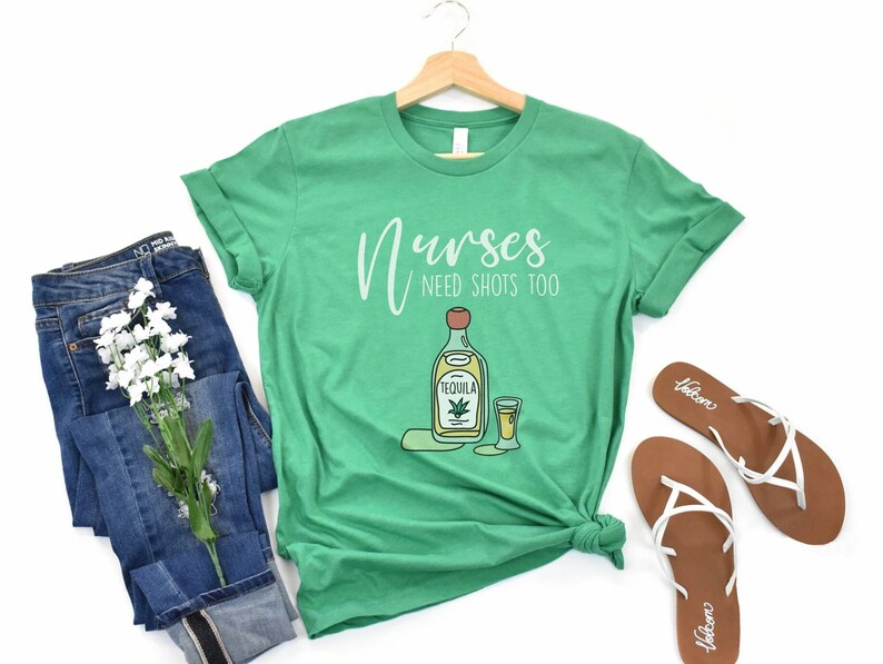 May include: Green t-shirt with the text "Nurses Need Shots Too" and a cartoon image of a bottle of tequila and a shot glass.