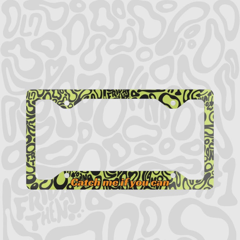 Green and black f1 themed lando norris car license plate frame is shown against a black and white lando norris pattern. Personalised phrase "catch me if you can" is shown on bottom of frame in orange mclaren themed text. 

Lando Norris F1 License Plate Frame: Green and black pattern, Aluminum