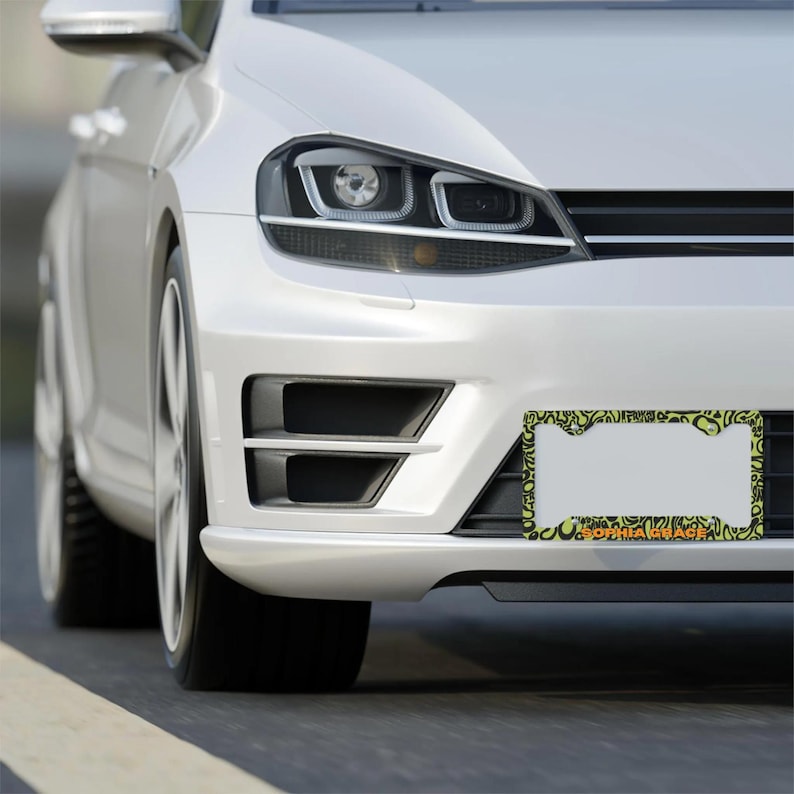 Green and black f1 themed lando norris car license plate frame is on the front of car. Frame shows personalised "lando norris" in orange text.

Lando Norris F1 License Plate Frame: Green and black pattern, Aluminum