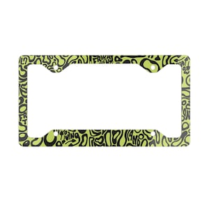 Lando Norris F1 License Plate Frame: Green and black pattern, Aluminum

Picture of lando norris number plate frame against a white background.