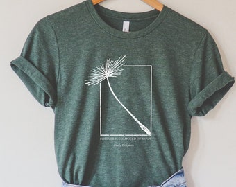 May include: A green t-shirt with a white dandelion graphic and the quote "Forever is composed of nows" by Emily Dickinson.