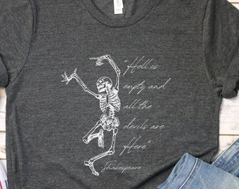 May include: A dark grey t-shirt with a white skeleton graphic and the quote "Hell is empty and all the devils are here" attributed to Shakespeare.