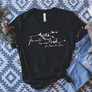May include: Black t-shirt with a white graphic design featuring a branch with birds and the text "The earth has music for those who listen."