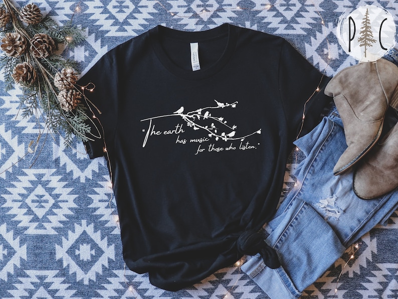 May include: Black t-shirt with a white graphic design featuring a branch with birds and the text "The earth has music for those who listen."
