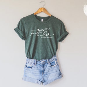 May include: A green t-shirt with a white graphic that says "The earth has music for those who listen". The graphic also includes a branch with birds and leaves.