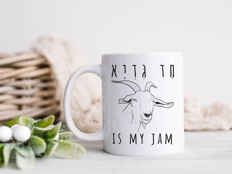 May include: White ceramic mug with a black line drawing of a goat and the text "Goat is my jam".