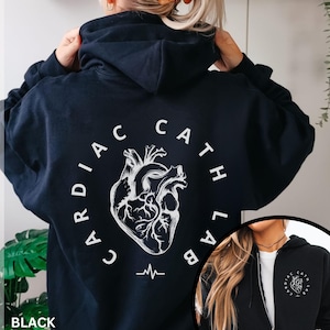 May include: Black hoodie with a white graphic of a heart and the text "Cardiac Cath Lab" on the back.