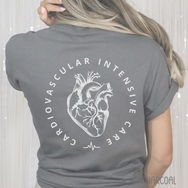 May include: Charcoal gray t-shirt with a white anatomical heart design inside a circular text that reads "CARDIOVASCULAR INTENSIVE CARE". A heartbeat line is below the heart graphic. The word "CHARCOAL" is at the bottom right.