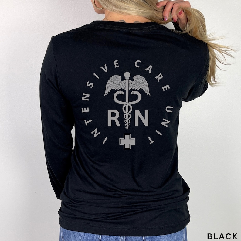 May include: Black long-sleeve shirt with a white graphic of a medical symbol, a snake wrapped around a staff, and the text "INTENSIVE CARE UNIT RN".