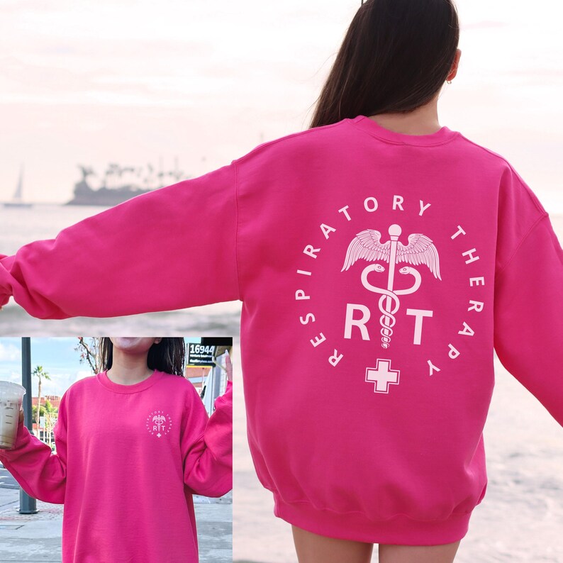 May include: Pink sweatshirt with a white graphic of a medical symbol and the text "Respiratory Therapy RT".