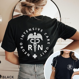 May include: A black short-sleeved t-shirt featuring a white graphic on the back with a caduceus symbol, the text "INTENSIVE CARE UNIT" and "NEURO RN", and a small cross. A smaller circular inset shows the same design on the front left chest.