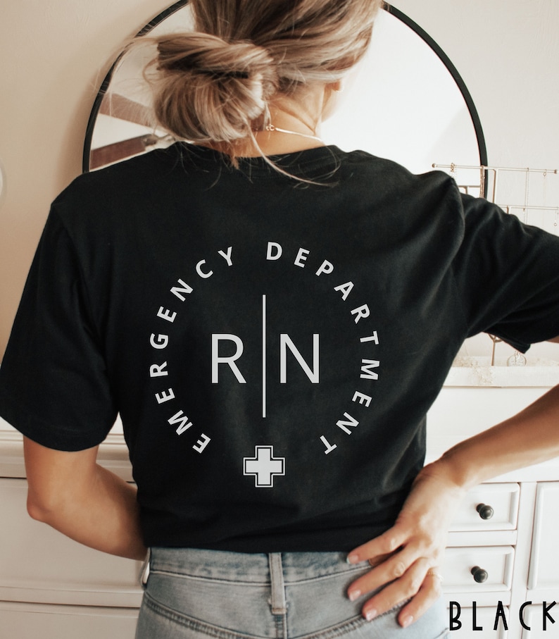 May include: Black t-shirt with a white circular design that reads "Emergency Department" around the top and "RN" with a cross below. The word "BLACK" is printed in the bottom right corner.