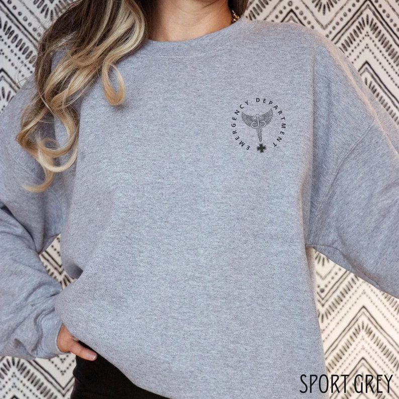 May include: A grey sweatshirt with the text "Emergency Department" and a medical symbol on the front.