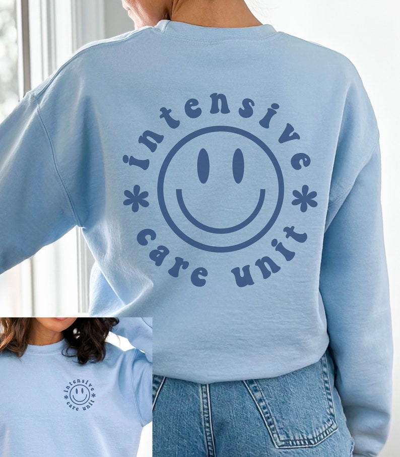 May include: Light blue sweatshirt with a blue smiley face and the text "intensive care unit" in a retro font.