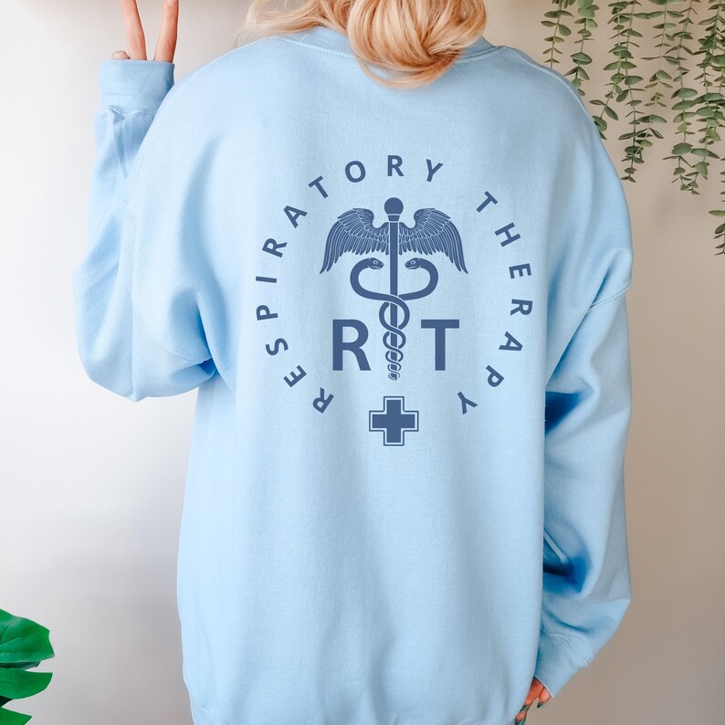 May include: Light blue sweatshirt with a graphic of a medical caduceus and the text "Respiratory Therapy RT" in a circle.