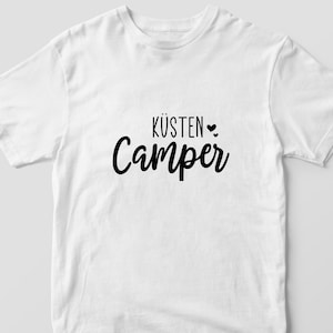 May include: White t-shirt with black text that reads "K&uuml;sten Camper" with a small heart symbol.