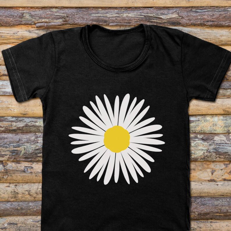 May include: A black t-shirt with a white daisy graphic. The daisy has a yellow center.