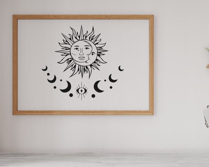 May include: A black and white illustration of a sun and moon with a third eye symbol in the center. The sun and moon are surrounded by crescent moons.