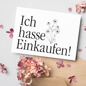 K&ouml;nnte beinhalten: Eine wei&szlig;e Karte mit schwarzem Text, der "Ich hasse Einkaufen!" lautet, mit einer einfachen schwarzen Linienzeichnung eines Blumenstrau&szlig;es.