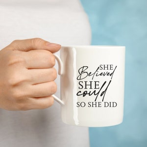 May include: White ceramic mug with black text that reads "SHE Believed SHE could SO SHE DID".