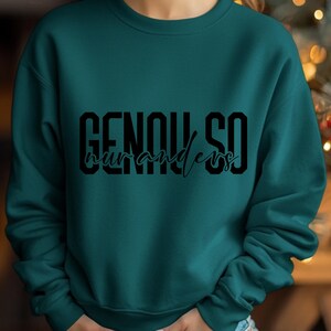 May include: Teal blue sweatshirt with black text that reads "GENUINE SO" and "wanderer" in a cursive font.