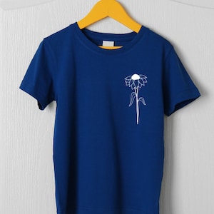 May include: A royal blue t-shirt with a white outline of a flower on the left chest.