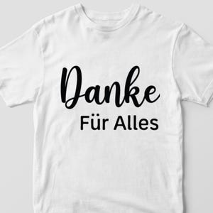 May include: White t-shirt with black text that says "Danke f&uuml;r Alles".