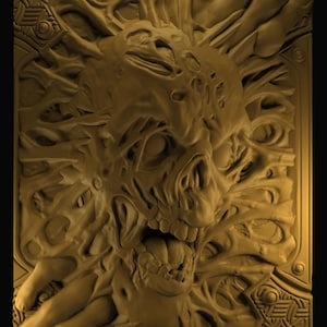 May include: A detailed, golden-toned relief sculpture featuring a grotesque skull with an open mouth and exposed teeth. The skull is surrounded by distorted, organic forms and hands, set within a decorative rectangular frame.