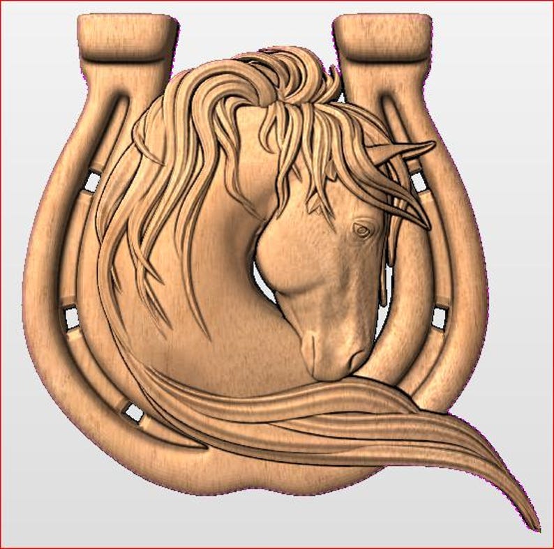 May include: A wooden carving of a horse's head within a horseshoe. The horse has flowing mane and detailed facial features. The horseshoe is a classic U-shape with nail holes. The carving is in shades of brown.