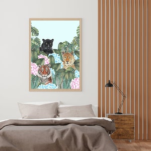 May include: A framed print featuring a black panther, a tiger, and a leopard in a jungle setting with blue and pink flowers. The animals are looking directly at the viewer.