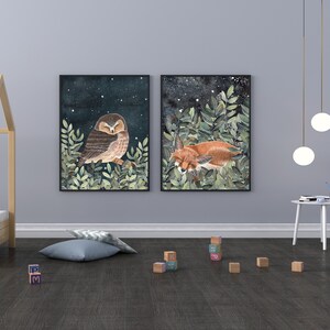 May include: Two framed illustrations of woodland animals. The first illustration features a brown owl with its eyes closed, perched on a branch with green leaves. The second illustration features a red fox curled up asleep in a bed of green leaves.