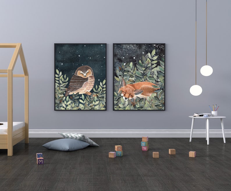 May include: Two framed illustrations of woodland animals. The first illustration features a brown owl with its eyes closed, perched on a branch with green leaves. The second illustration features a red fox curled up asleep in a bed of green leaves.