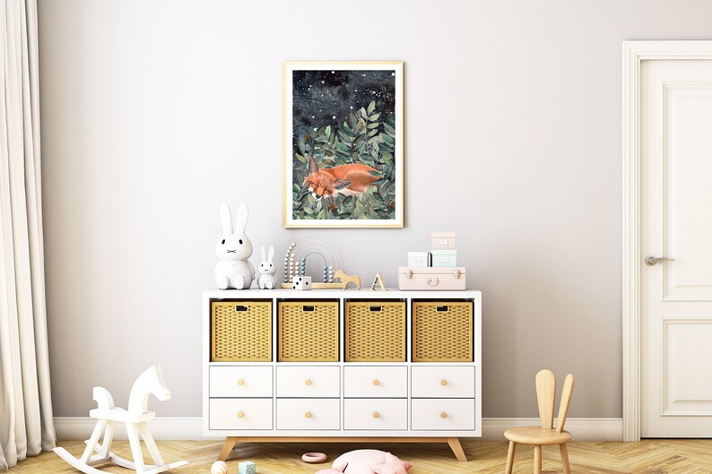 May include: A white dresser with wicker baskets and drawers, a rocking horse, a small white rabbit, a larger white rabbit, and a framed print of a fox sleeping in a forest with a starry night sky.